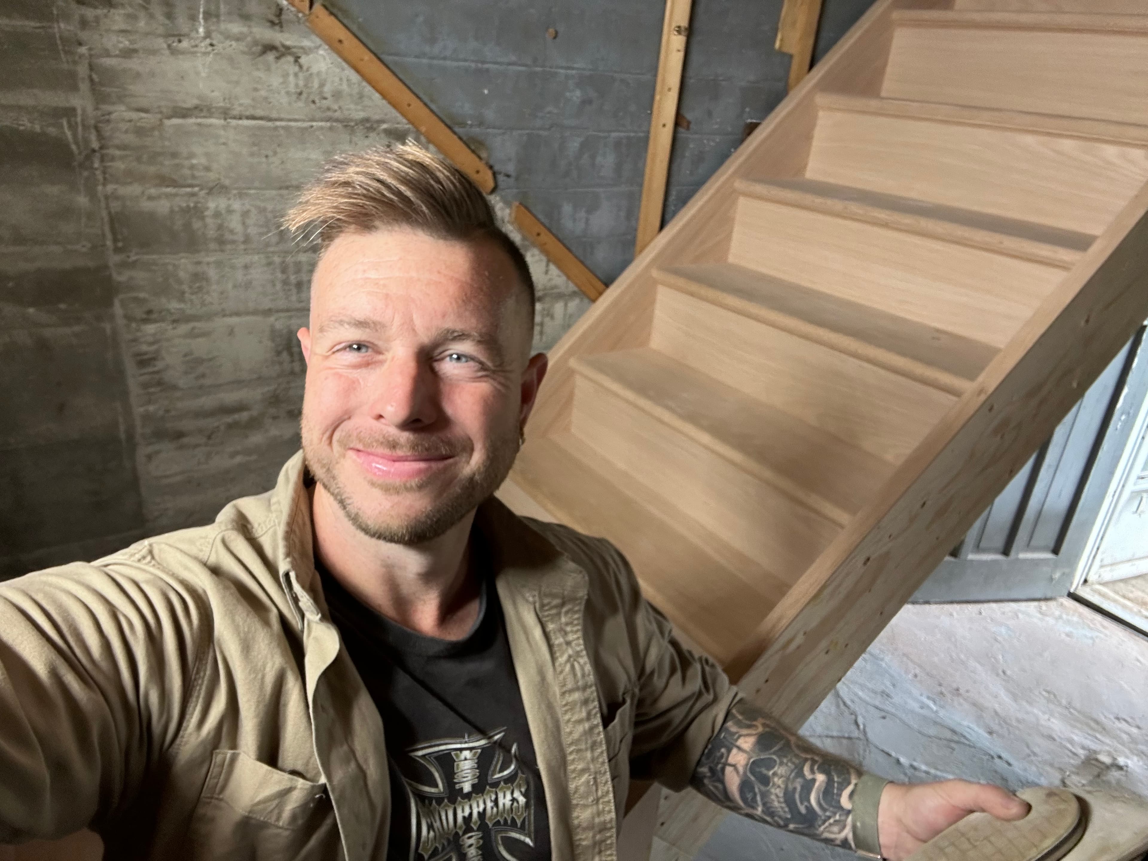 Raw unfinished wood staircase under construction.